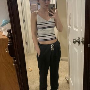 White, purple and black striped tank top showing midriff.